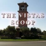 A clock tower with the words " the vistas scoop ".